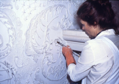 Artist applying plaster designs on a wall