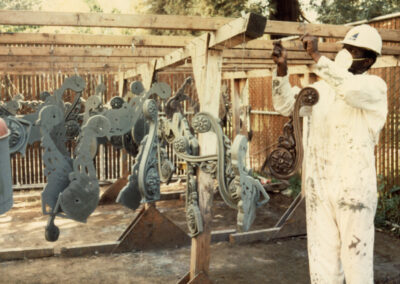 Metalworker hanging cast iron ornaments to dry