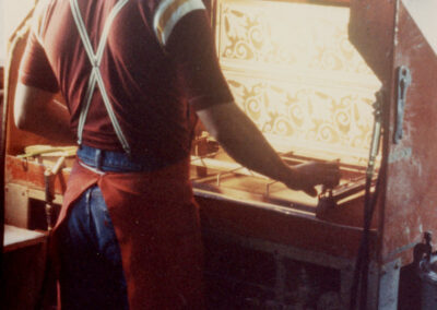Tile worker using screens to paint Eureka tiles