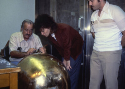 Workers polishing the gold ball for the top of the dome